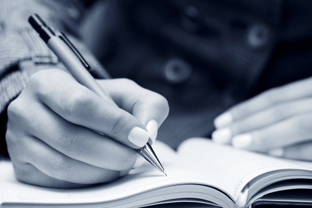 bigstock-business-woman-writing-in-note-73423432